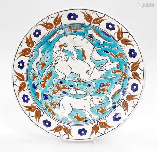 A Portuguese style pottery charger, on a white and blue glaz...