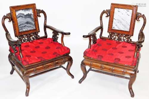 A pair of Chinese hardwood armchairs, carved in imitation of...