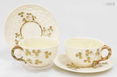 A pair of Belleek black mark second period tea cups and sauc...