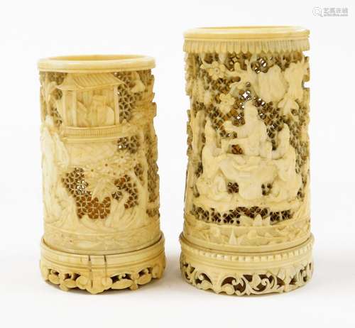 Two Chinese carved and pierced ivory vases, one depicting fi...