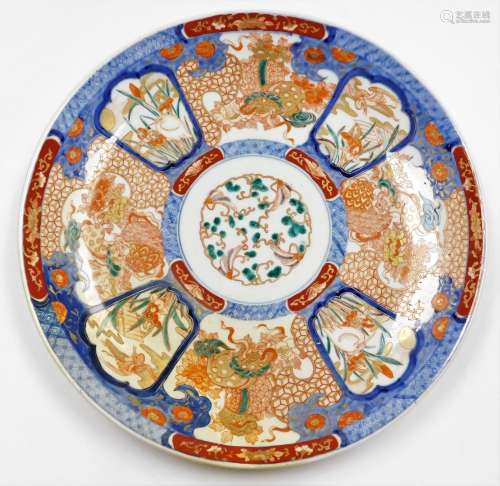A Japanese porcelain Imari charger, decorated with shishi an...