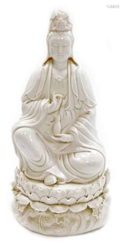 A Chinese blanc de chine figure of Guan Yin seated on a lotu...