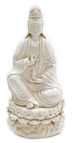 A Chinese blanc de chine figure of Guan Yin seated on a lotu...