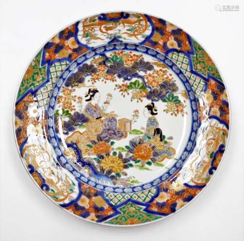 A Japanese porcelain Imari charger, decorated with a central...