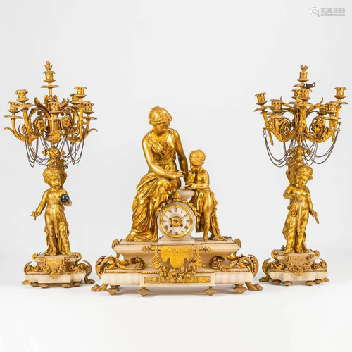 A 3 piece gilt garniture clock, decorated with putti a