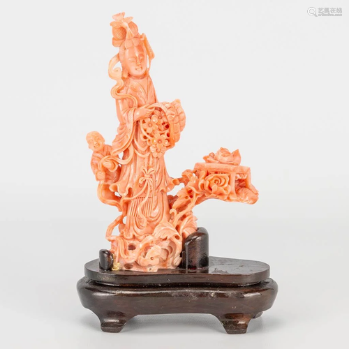 A Chinese pink coral sculptured statue of a lady with