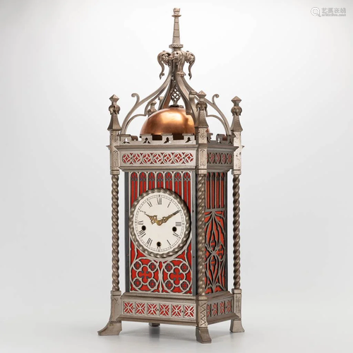 A clock made of metal in neogothic style with 9 bells,