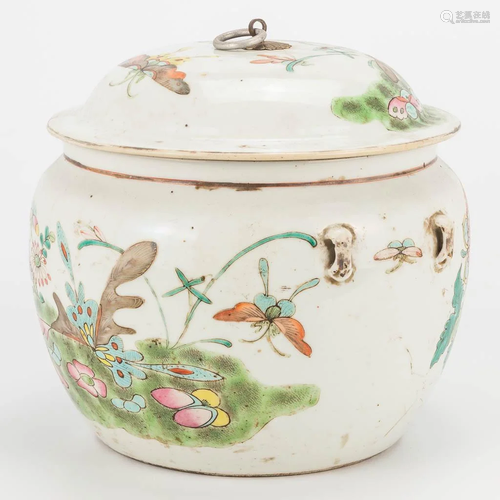 A Chinese porcelain jar with lid, with flower and