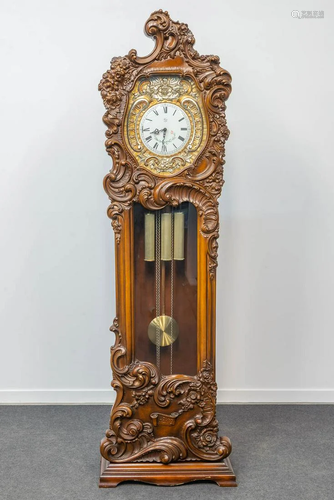 A roccoco standing clock, sculptured wood with