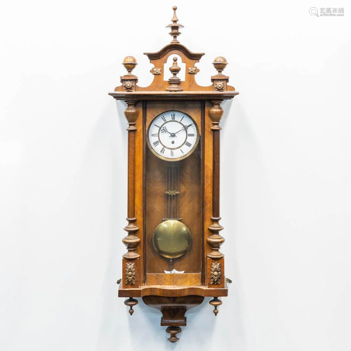 A wood hanging clock. The first half of the 20th