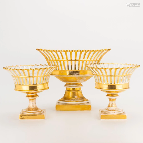 A collection of 3 vases, 2 round and one oval, with