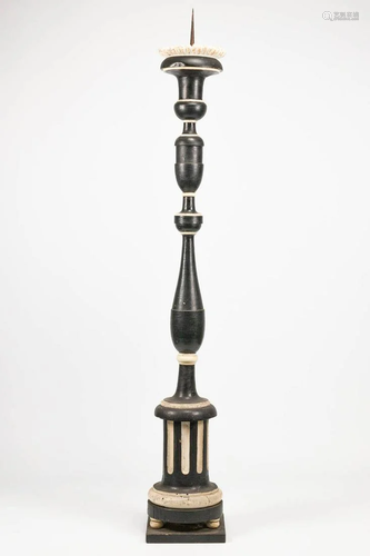 A church candlestick made of patinated wood.The second