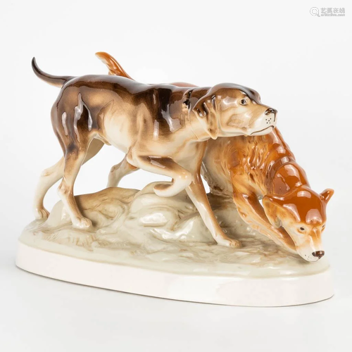 A statue of 2 dog figurines, made of porcelain in