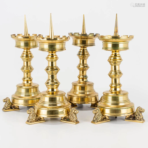 A collection of 4 identical church candlesticks made of