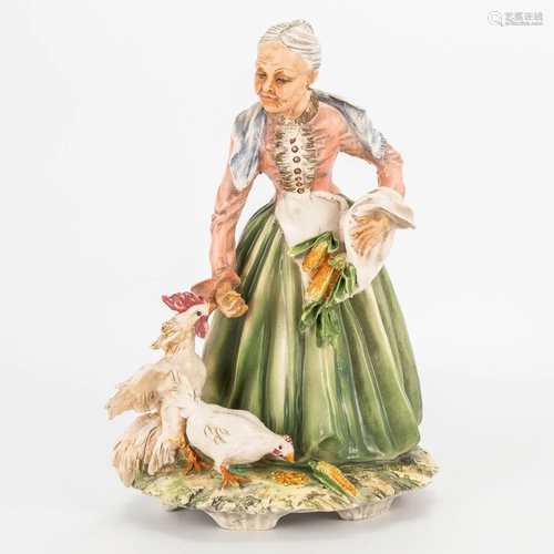 A faience group of an old lady with chicken, marked