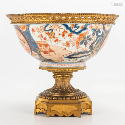 A Japanese Imari porcelain bowl mounted on a bronze