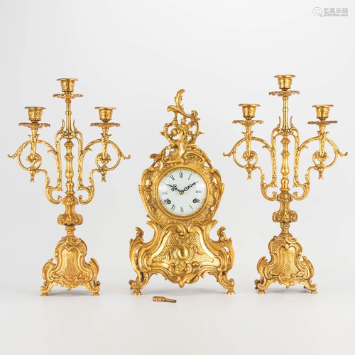 A 3 piece garniture clockset made of bronze, consisting