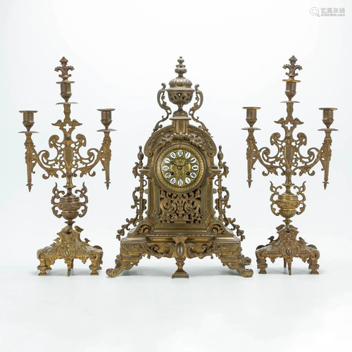 A 3 piece garniture clockset made of bronze, consisting