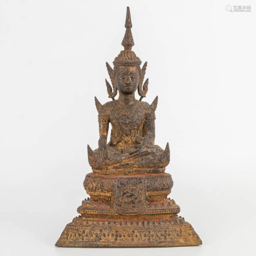 An antique Oriental Buddha, made of patinated bronze.
