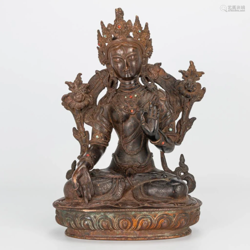 A bronze statue of Guanyin, decorated with