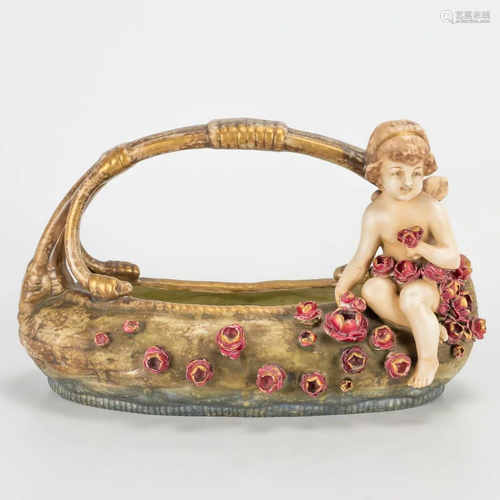 A basket with flowers and an angel, made of faience in