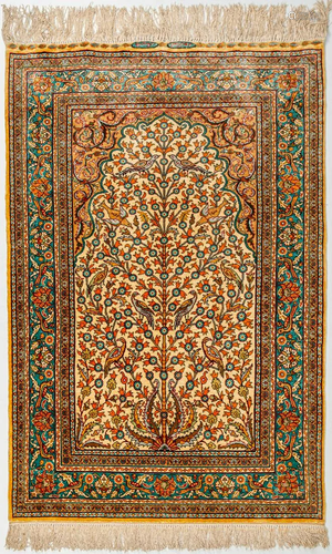 A hand-made silk carpet with 'Tree of life' decor and