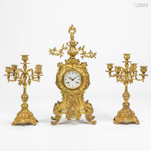 A 3 piece garniture clock made of bronze. 20th century.