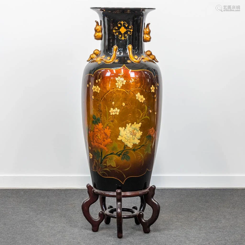 A large Oriental and decorative ceramic vase on wood