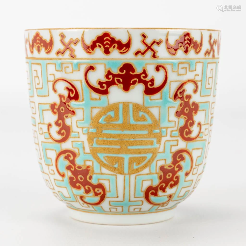 A beaker made of Chinese porcelain with symbols of