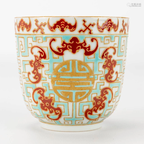 A beaker made of Chinese porcelain with symbols of