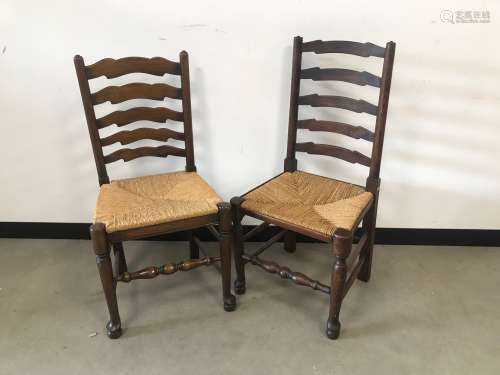 A pair of modern ladder back dining chairs