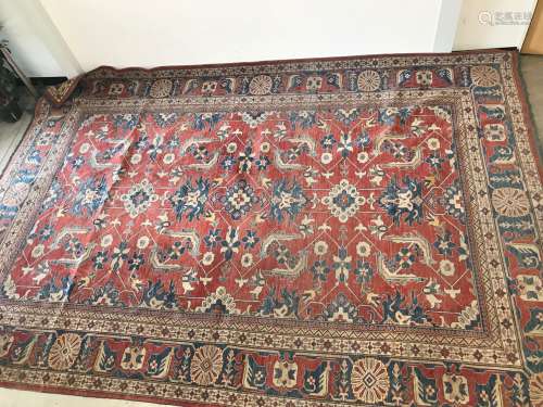 A large Caucasian woollen carpet, 406 cm by 284 cm, red grou...