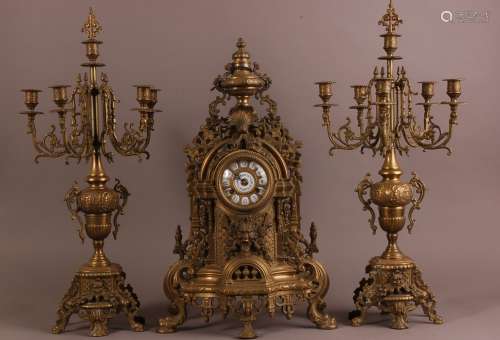 An early 20th century French brass clock garniture, having a...