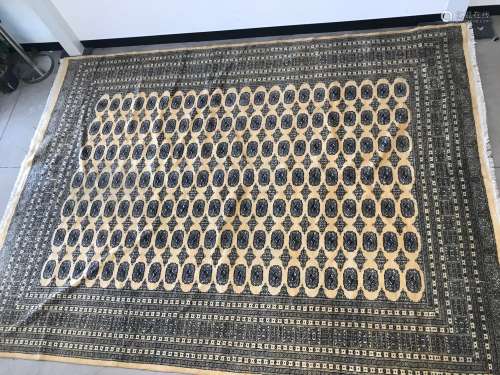 A large middle eastern woollen carpet with yellow ground and...
