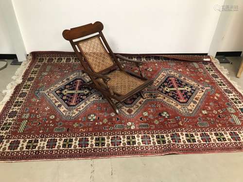 A vintage Caucasian carpet, light red and cream ground with ...