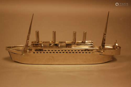 A modern chromed model of a boat, 45cm long