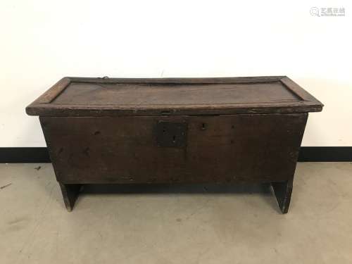 An early 18th century oak plank chest, with pin hinge top, s...