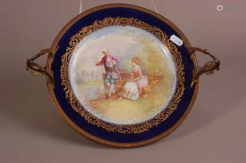 An early 20th century Sevres porcelain plate, mounted in a g...