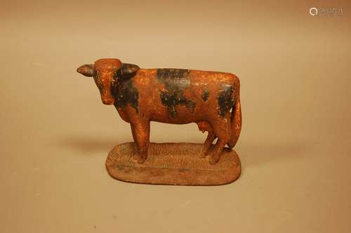 A vintage cast iron doorstop, modelled as a cow, 21cm wide