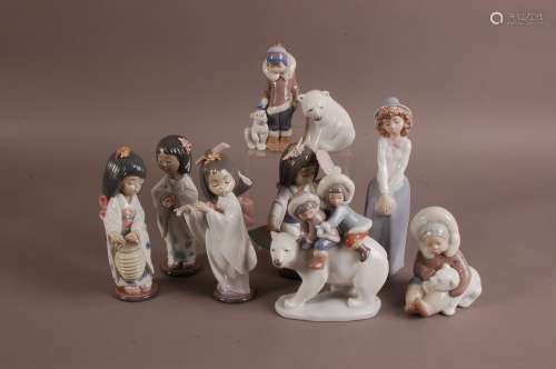 A group of nine Lladro and Nao porcelain figures, including ...