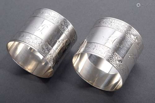 Pair of round, richly engraved napkin rings with monograms 