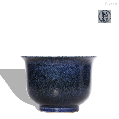 A blue glazed cup