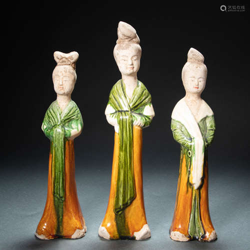 A GROUP OF CHINESE THREE-COLOR GLAZED LADIES FROM TANG DYNAS...