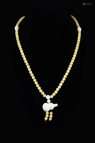 A Golden Streak Tridacna Bead Necklace with a Calabash