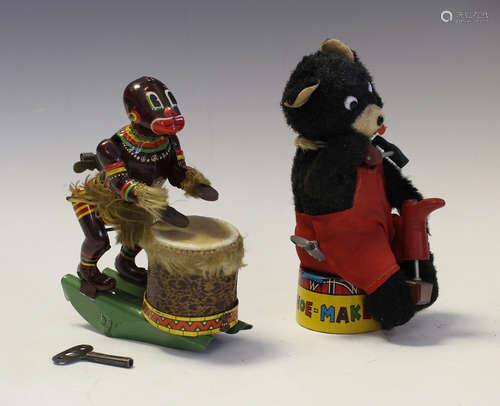 A Japanese clockwork toy in the form of a bear shoemaker, he...