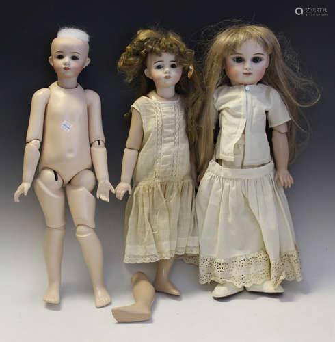 A modern K & R bisque head doll with blonde wig, fixed blue ...