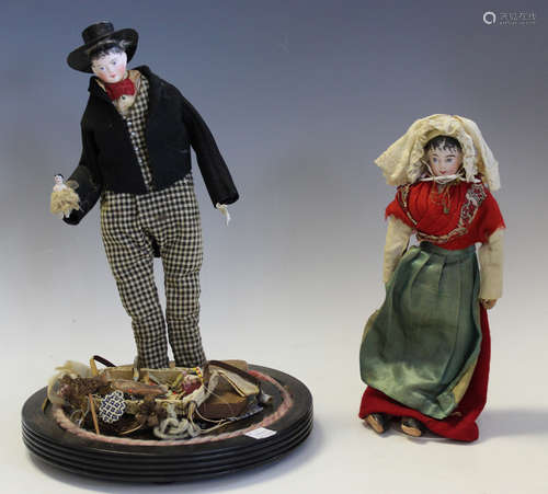 A bisque head pedlar doll with painted features and wooden b...