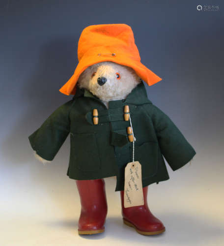 A Gabrielle Designs Paddington Bear, wearing an orange hat, ...