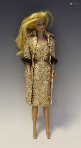 A 1960s Mattel Barbie doll with straight legs, wearing a whi...