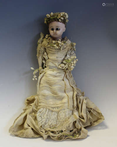 A 19th century wax head and shoulders bride doll with blonde...